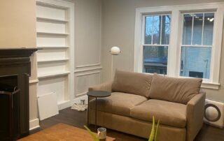 A white and beige painted living room with sofa, coffee table and some house decor. Right Interior Paint Sheen for Every Room